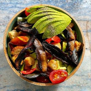 Paradeco signature mushroom bacon sitting on a fresh bed of St. Pete Brick Street Farms hydroponic greens. Grape tomatoes, avocado and our very own house made Champagne Vinaigrette at Paradeco Coffee Roasters in St Petersburg