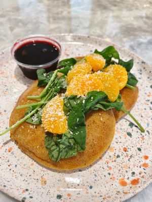 GF Vegan orange infused pancakes! With toasted coconut, Mandarin organes and arugula on top.   at Paradeco Coffee Roasters in St Petersburg