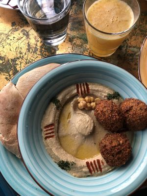 Hummus and falafels, fresh orange juice  at KAFKA Hummus Café  in Prague