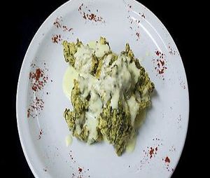 Buñuelos de espinaca (con salsa de crema y queso) at Almacen Purista in Buenos Aires