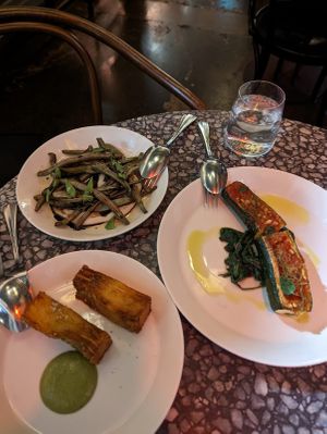 Confit Roman beans, garlic & balsamic vinegar $18; Roasted tomato & pine nut filled zucchini w/pangrattato, greens & garlic $32; Potato gratin, citrus, thyme & tarragon $18 at Patsy's in Melbourne