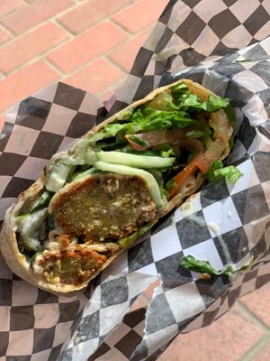 Falafel wrap. Perfectly seasoned falafel with lettuce, cucumbers and pickles with sauce.  at Stillfood Bistro in Salmon Arm