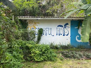 Road entrance and parking area at Colorful Hut in Koh Phangan