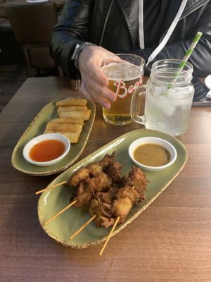 Satay chicken skewers and spring rolls   at Vegan Planet in North West London