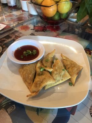 Lions mane rangoon topped with scallions and comes with a sweet and spicy sauce. at Fiction Kitchen in Raleigh