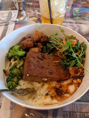 A grits bowl with veggies and tofu and chili crisp at Fiction Kitchen in Raleigh