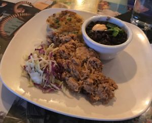 Eastern NC Style BBQ Pulled "Pork" with smashed potatoes and black beans with chipotle buttermilk and cilantro.  at Fiction Kitchen in Raleigh