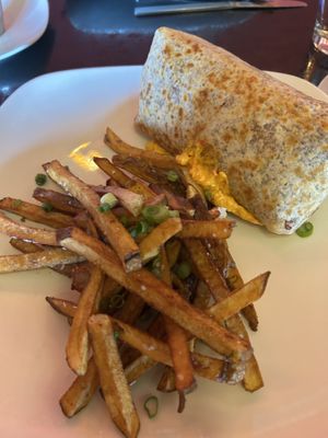 Special gluten free burrito with vegan popcorn chicken, cheese, veggies and special sauce.  House made pickle dipped potato fries.  at Fiction Kitchen in Raleigh