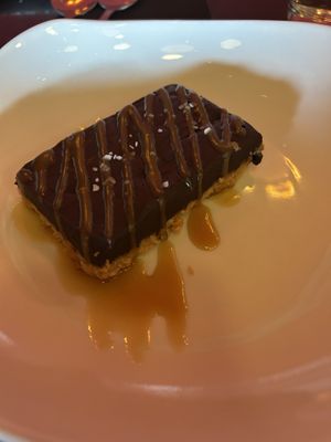Chocolate truffle bar with almond crust and caramel sauce.   at Fiction Kitchen in Raleigh