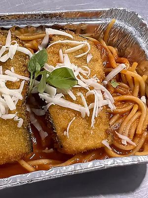 Breaded eggplant served over spaghetti without eggs topped with homemade tomato sauce. at Belle de Jour Botequim in Natal