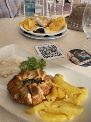 In the foreground is my crunchy spinach with vegan cheese. It was a pie and came with lettuce and chips, plus a smear of something that was a cross between hummus and mayo.   at Restaurante Seis Perlas in El Campello