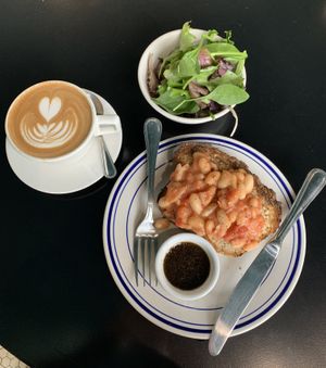 Beans and Tomatoes Toast with Side Salad  at Leslie Coffee Co in Wichita