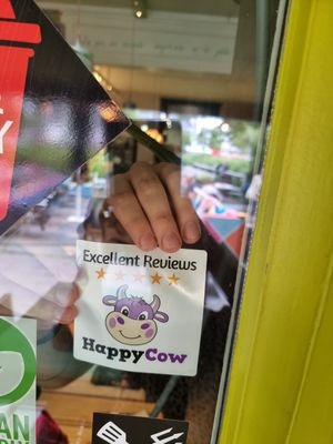 Gave the a Happy Cow decal, which they immediately put up! at Pura Vida Vegan Tacos in Antwerpen