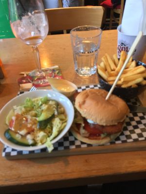 Vegan mozzarella crispy chkn burger with fries and side salad + an aperol spritz.  at Pura Vida Vegan Tacos in Antwerpen