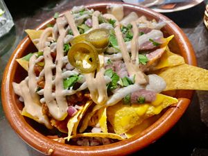 Loaded Nachos:
Homemade cheddar, bean paste, pico de gallo, jalapeños, chipotle mayo, guacamole, onion and coriander at Pura Vida Vegan Tacos in Antwerpen
