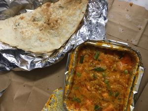 Take away curry veggies and garlic naan at Rangoli Indian Restaurant in Padua