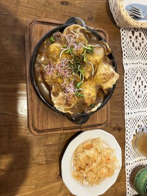 oven backed brokkoli pierogi with mushroom sauce and vegan cheese   at Pod Przykrywką in Wroclaw