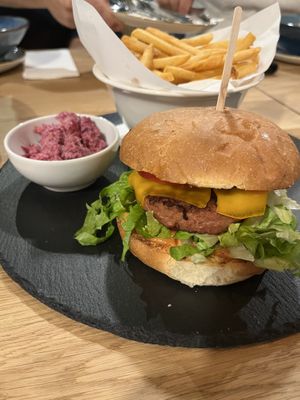 Burger with fries/beet cole slaw. Burger is not Beyond Meat and has an odd after-taste.  at Vegan Garden Budapest in Budapest