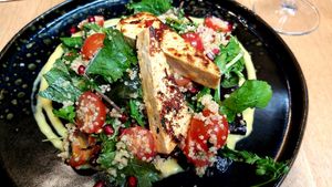 Quinoa Salad with pomegranate, mango dressing and grilled tofu marinated in sweet chili at Vegan Garden Budapest in Budapest