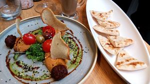 Hummus with tomatoes, home made pita bread and green pea balls at Vegan Garden Budapest in Budapest