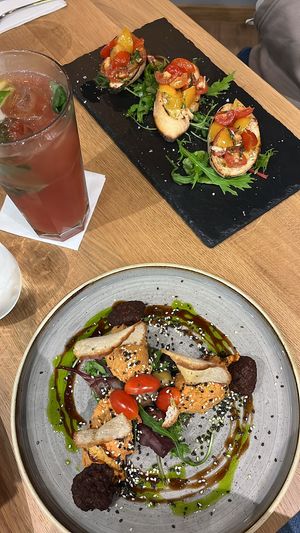 Starter 1: Sundried tomato hummus with green pea balls and pita bread. Starter 2: Bruschetta  at Vegan Garden Budapest in Budapest