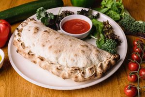 Calzone:
Vegan sour cream with garlic and parsley, garlic spinach, smoked tofu, sun-dried tomato at Vegan Garden Budapest in Budapest