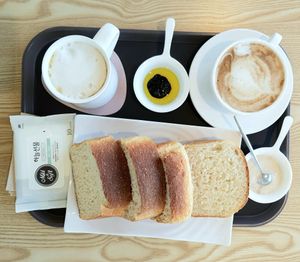 loaf of fresh bread with sauces and coffee at Fortunate Coffee - 씽푸커피 in Ansan