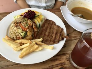 Paella w broccoli & meaty chunks, salad w creamy citrus dressing, quinoa meat w hammy flavors, carrot soup, hibiscus tea = happily stuffed! at Govinda's in Santa Marta