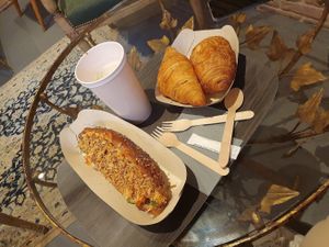 Not-dog, pain au chocolat, croissant, oat milk latte at Bulle in Paris