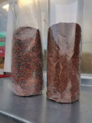 Bounty chimney cake (on the right) and "Rainbow" (with candies on it) on the left.  at Royal Street Food - Kürtőskalács in Tatabanya