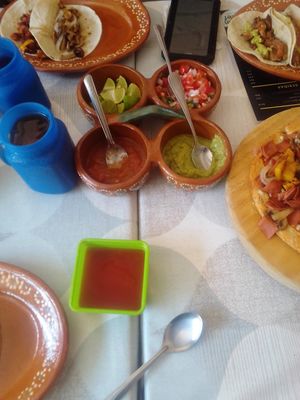 Array of dressings and the king of condiments in the green bowl:) at 100% Vegana Taqueria in Puerto Vallarta