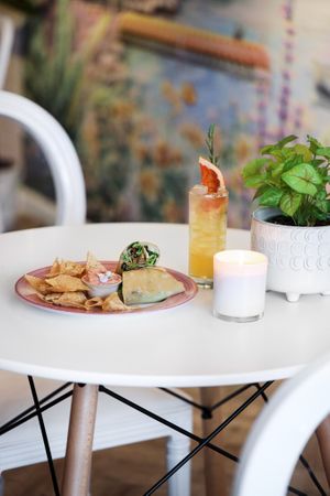 Maple tahini caesar wrap in a cassava tortilla, served with a side of grain-free chips and house-made beet hummus at Elixir De La Lune in La Jolla
