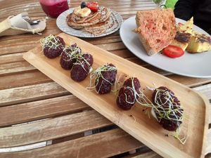 Grate croquetas made out of red beet,corn and quinoa at ECO DEL MAR in Blanes
