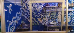 Hours and the HappyCow logo at Varuna Plant-Based Food & Juice Bar in Manuel Antonio