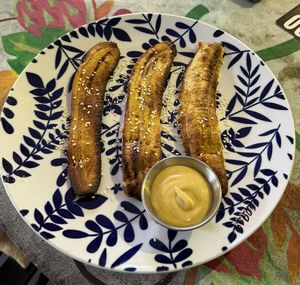Sweet and spicy Plantains. Plantains themselves are great but thos were kinda dry and I didn‘t like the cheese sauce.  at Varuna Plant-Based Food & Juice Bar in Manuel Antonio