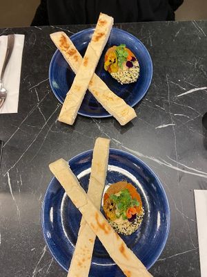 Avocado filled with hummus, sesame seeds and paprika with pita bread    at The Avocado Show in London