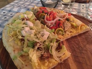 “Pinsa” (I think) you and me. Sharing dish with tuna and tomato or vegan sausage and cheese.  at Raparossa  in Pezze Di Greco