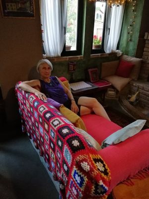 Reclining on the comfy sofa by the fire after dinner. at Lucciola Organic Bistro in Corfu