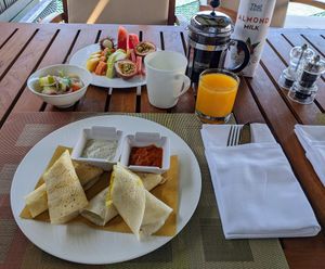 Vegan breakfast dosa, fruit plate, juice, coffee with almond milk at Ayada Maldives in Maguhdhuvaa Island
