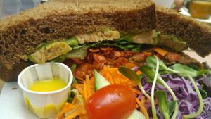 park avenue - avocado spread, tomato, tempeh, spinach, added coconut bacon.  at Cafe Santropol in Montreal
