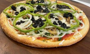 Vegan Veggie Special Pie with Esti shredded vegan mozzarella, broccoli, spinach, mushrooms, onions, green peppers & black olives. at Famous Pizza in Paramus