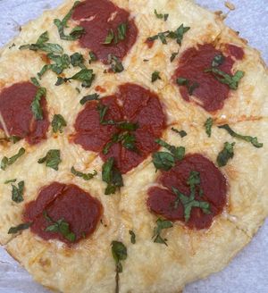 Vegan Grandma pie with NuMU shredded mozzarella, dollops of the signature sauce and fresh basil at Famous Pizza in Paramus