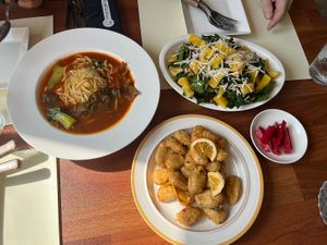 Hot tomato noodle soup, orange chicken, orange salad  at Camouflage in Seoul