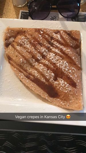 Vegan Crêpe with Strawberries and Cherries, Drizzled with Coconut Carmel Sauce and Dusted with Powdered Sugar at Chez Elle in Kansas City