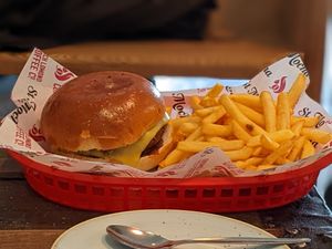Vegan burger, vegan cheese, vegan brioche bun, and fries! at The Station Coffee Shop in Aberfoyle