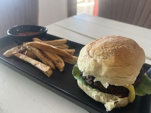 Homemade bean burger patty with cashew cheese, avo, caramelized onions with freshly cut fries  at Seawiches Lounge Bar in Roatan
