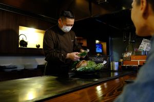 Chef, Shiga-san, picking out seasonal vegetables to use in our vegan okonomiyaki at TEPPANYAKI RAI in Ninohe