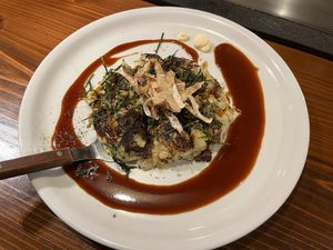 Vegan okonomiyaki with cabbage, green onion, burdock root, etc. and vegan okonomi sauce at TEPPANYAKI RAI in Ninohe