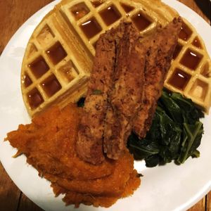 chicken n' waffles with a yam mash and collard greens!! at The Hogtown Vegan in Toronto