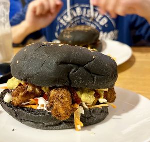 We asked for a BBQ burger (fried soy chunks, cole slaw, this burger was on the old menu, not on the new menu), but with a black bun and avocado sauce. It turned out divine! at Future Diner in Yerevan